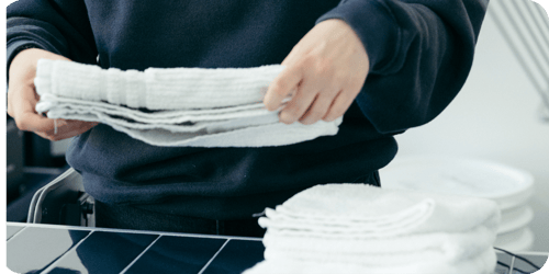folding towels in laundromat