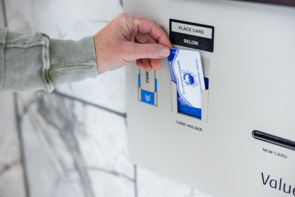 Customer placing laundry card in VAC